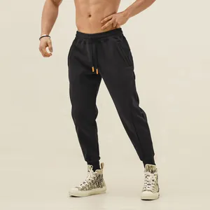 Close-up of men's tapered sports sweatpants with drawstring and elastic cuffs