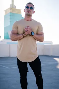 Professional lifestyle view of muscular fit khaki t-shirt with curved hem design