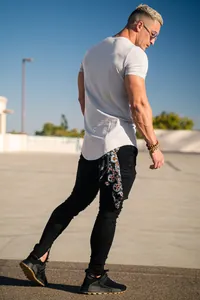 Back view of a man wearing a slim-fit light grey cotton T-shirt for casual streetwear