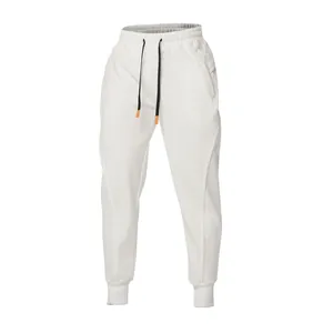 Close-up of white men's joggers with black drawstrings and functional zipper pockets