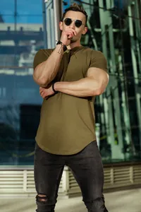 Detailed view of olive green muscle fit T-shirt featuring a modern curved hem design