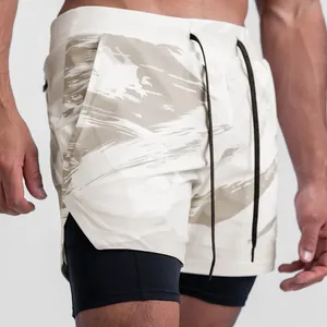 Close-up of men's double-layer sports shorts with abstract print and black inner compression layer.