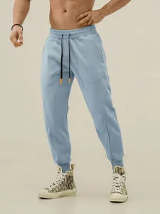 Light blue men's athletic joggers with drawstring waist and tapered cuffs for fitness