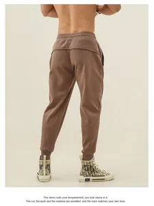 Men's brown athletic sweatpants with tapered ankle cuffs for gym and running sessions.