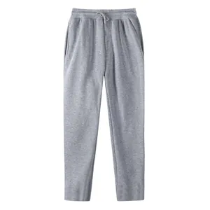 Close-up detail of grey men's straight-leg cotton sweatpants with drawstring waistband