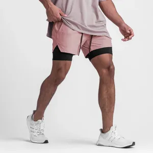 Detailed view of pink men's 2-in-1 athletic shorts with breathable black inner layer
