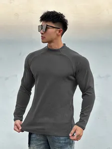 Men's slim fit dark grey long sleeve thermal t-shirt showing athletic muscle fit