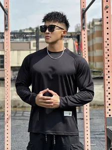 Detail view of men's black breathable mesh long sleeve sports T-shirt outdoors