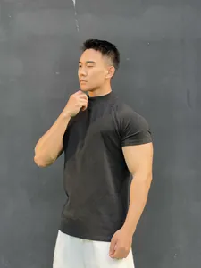 Close-up of men's athletic mock neck gym t-shirt in charcoal grey showing premium slim fit design