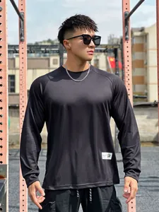 Detailed view of men's black athletic mesh long sleeve T-shirt perfect for gym training