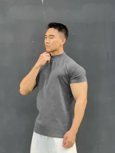 Close-up of athletic men's grey mock neck t-shirt showing fit and fabric texture
