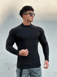 Detail view of men's slim fit black long sleeve crew neck thermal shirt on model