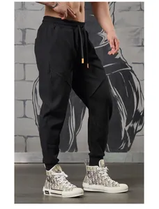 Side detail of men's black paneled sports joggers with tapered cuffs