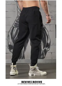 Back view of professional men's black fitness joggers with elastic waistband and tapered cuffs