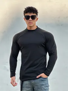 Close-up of slim fit black long sleeve muscle t-shirt on male model