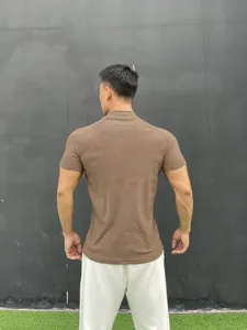 Back view of men's brown slim-fit mock neck fitness t-shirt with raglan sleeve design.