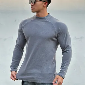 Macro view of grey thermal long sleeve shirt showing slim muscle fit on a male model
