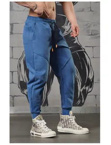 Detailed close-up of blue men's joggers featuring unique stitching and tapered leg fit
