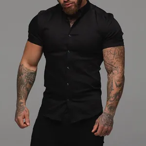 Close-up of a men's black muscle fit short sleeve stretch shirt on model