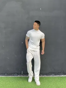 Detail view showing the athletic fit of a white high-neck short-sleeve men's t-shirt
