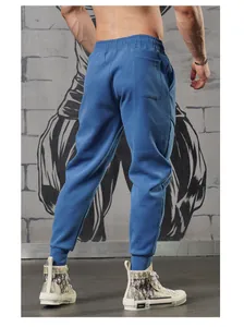 Detail view of blue sports joggers for men with elastic cuffs for fitness training.