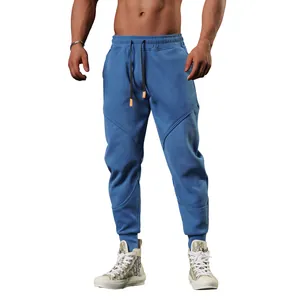 Detail of men's blue jogger pants with unique curved stitching and ribbed cuffs