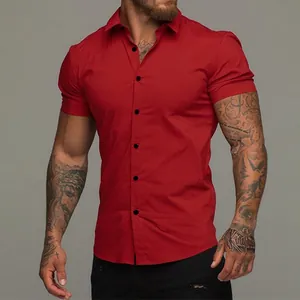 Close-up view of a men's muscle fit short sleeve solid red shirt on a model exhibiting texture