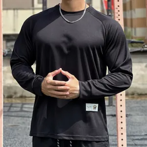 Detail of a men's loose black mesh long sleeve shirt for gym and outdoor sports