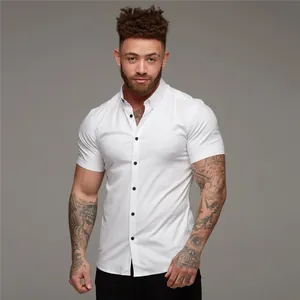 Detailed view of an athletic men's muscle fit white short sleeve button down stretch shirt