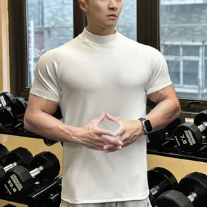 Detailed shot of men's slim fit mock neck short sleeve gym t-shirt in beige