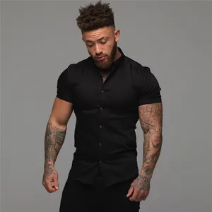 Close-up of a men's muscle fit black short sleeve stretch shirt with collar.