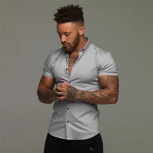 Macro detail of men's slim fit elastic grey short sleeve button-up shirt on model