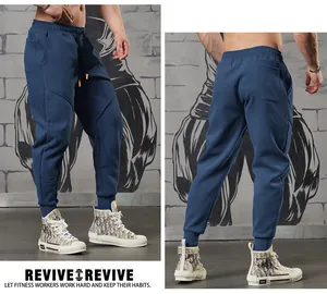 Close-up detail of men's blue fitness joggers with 3D stitching and cuffed ankles design