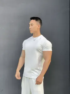 Slim fit men's white fitness t-shirt made of breathable cotton on an athletic model.
