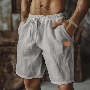 Men's breathable white linen shorts with drawstring waist and brown leather patch detail