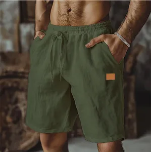 Close-up of men's army green cotton linen shorts with drawstring and patch detail