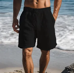 Detail view of men's black cotton linen beach shorts with drawstring elastic waist