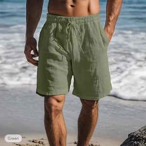 Close-up view of casual men's green cotton linen beach shorts with drawstring waist