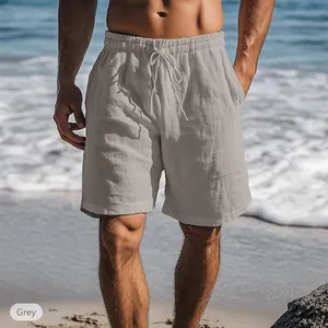 Detail view of men's breathable linen shorts with drawstring waist on beach