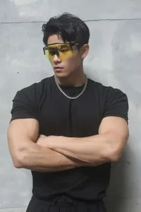 Macro detail of a high-quality heavy weight black gym T-shirt on a muscular male model.