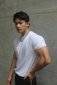 Detail view of white slim fit men's gym t-shirt highlighting athletic muscular build