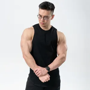 Athletic model wearing a black slim-fit cotton tank top for gym training and running.