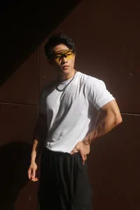 Male model wearing a heavy white Sorona crew neck sports t-shirt in bright sunlight