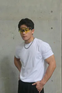 Athletic fitness model wearing a white heavyweight crew neck training T-shirt in detail.
