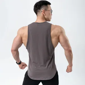 Back view of a taupe slim-fit cotton fitness tank top with a scoop hem for muscular men