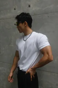 Side view detail of a heavyweight white Sorona T-shirt on a muscular fitness model