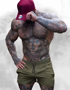 Athletic olive green workout shorts for men showing a fitted performance cut on a model.