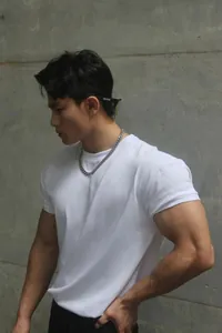 Close-up of a men's slim fit white heavyweight Sorona crew neck T-shirt on a muscular model