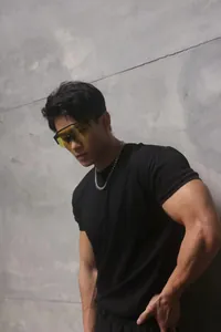 Muscular model wearing a black slim-fit Sorona workout t-shirt in a fitness pose