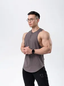 Breathable cotton muscle fit athletic tank top for men shown on model in studio setting